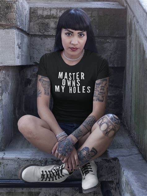 Woman in t-shirt with tattoos on step