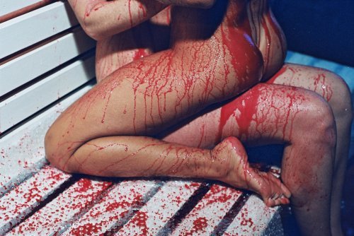 naked couple covered in blood